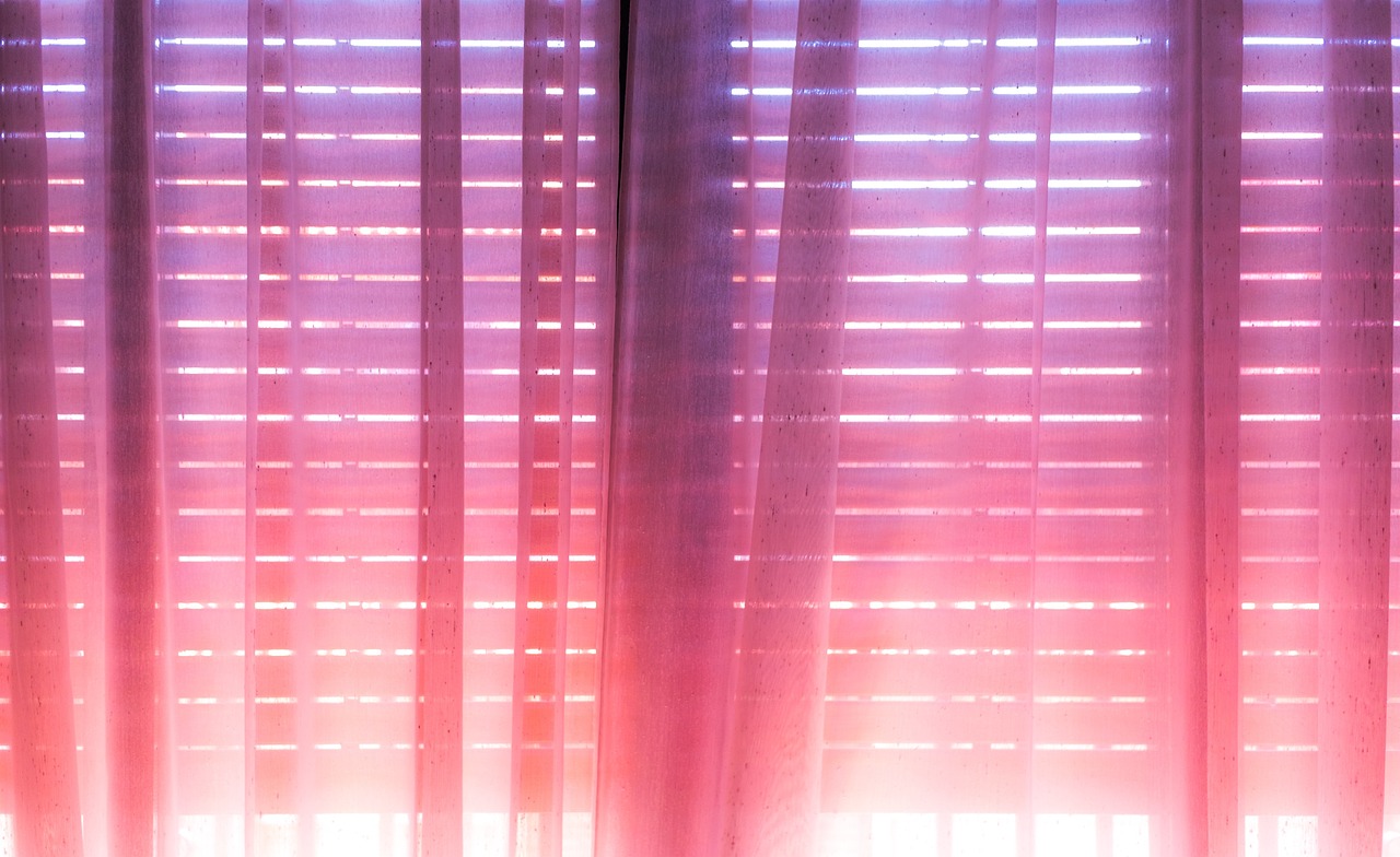 Light curtains diffusing bright summer sunlight at a window